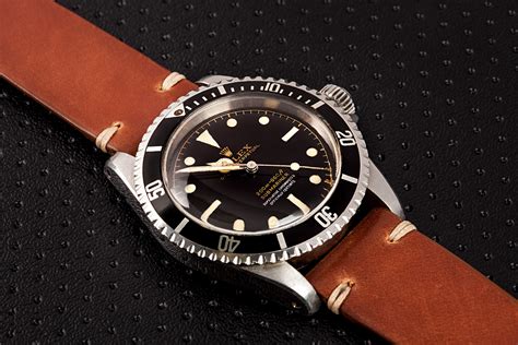 rolex submariner on leather strap.